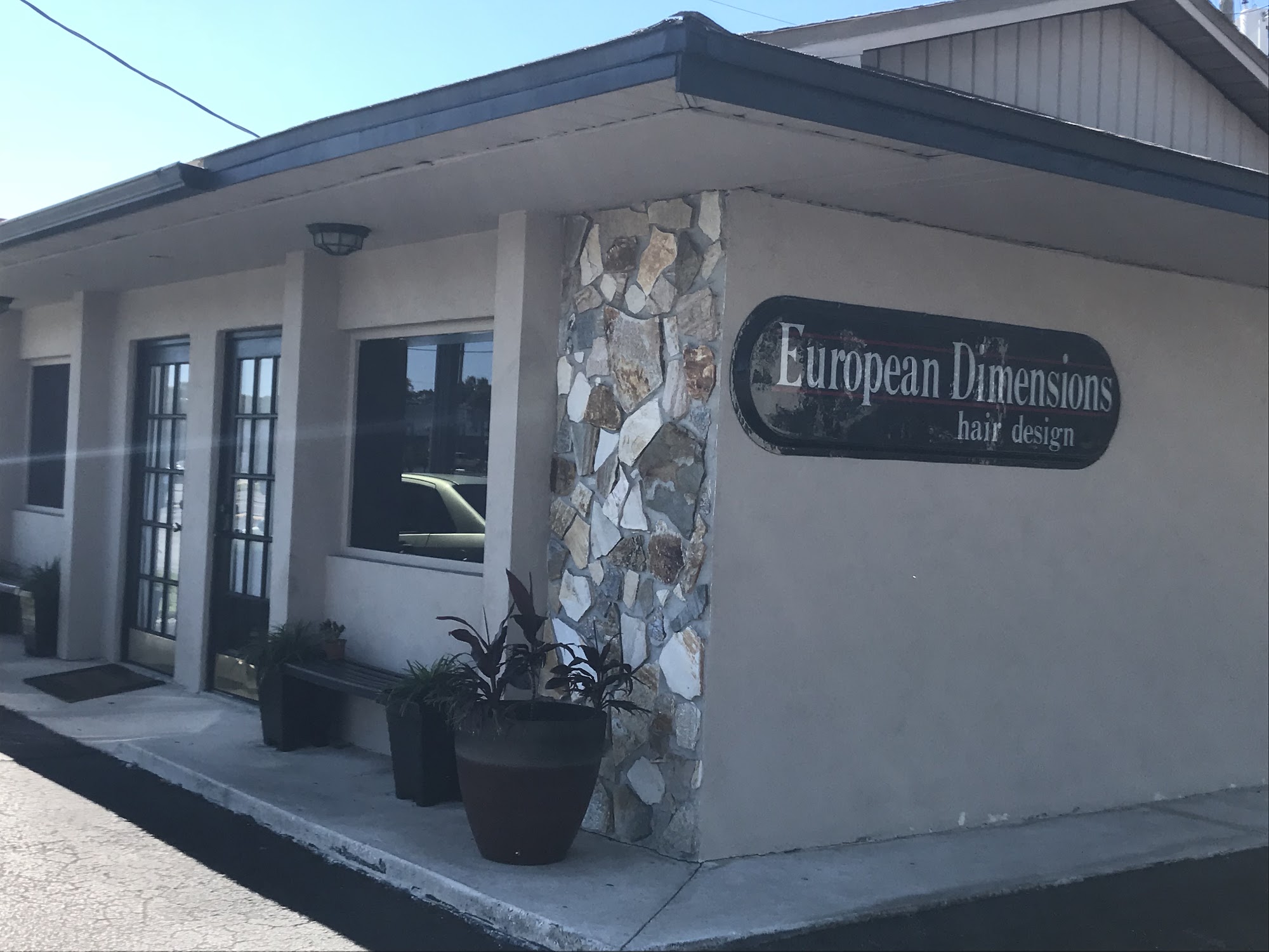 European Dimensions storefront on Florida Avenue South, a stone-clad corner with the salon sign